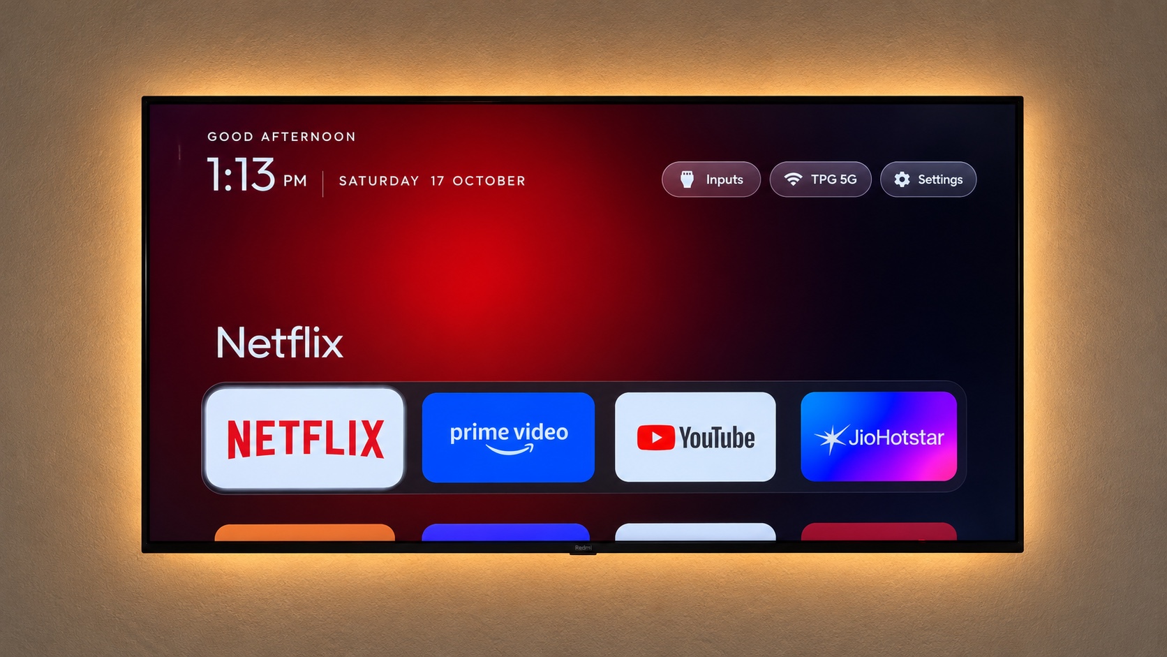 A clean TV home screen with favourite apps, a clock and settings